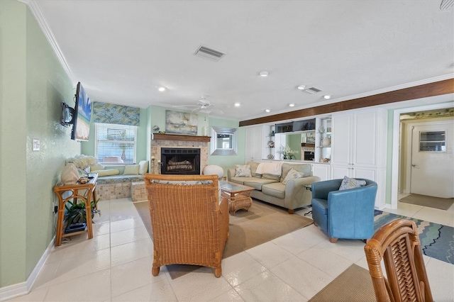 living room with ceiling fan, a fireplace, light tile patterned floors, and ornamental molding