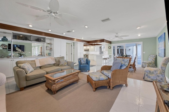 living room with light tile patterned floors, ceiling fan, and sink