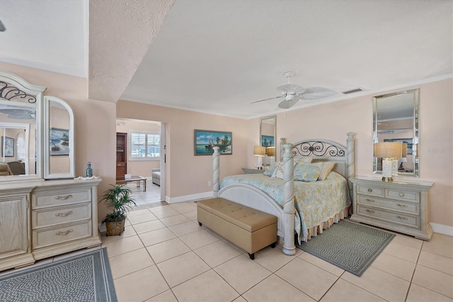 bedroom with light tile patterned floors, ceiling fan, and ornamental molding