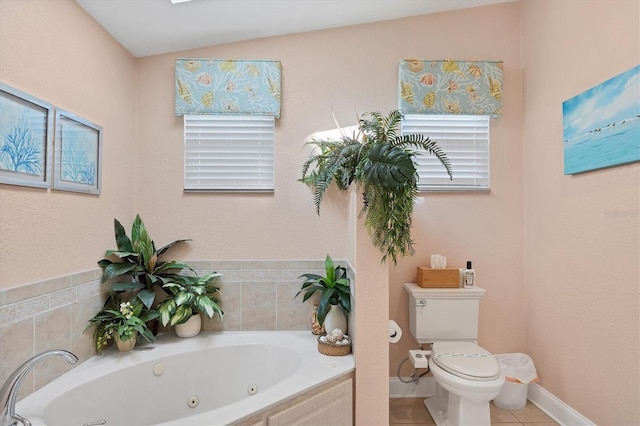 bathroom featuring tile patterned floors, tiled tub, vaulted ceiling, and toilet