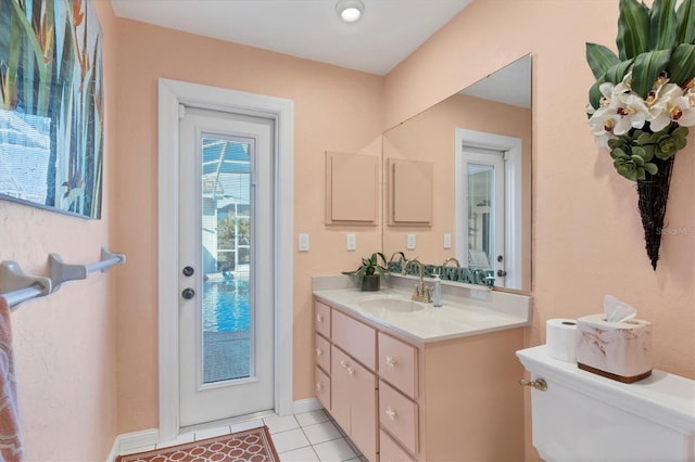 bathroom featuring tile patterned floors, vanity, and toilet