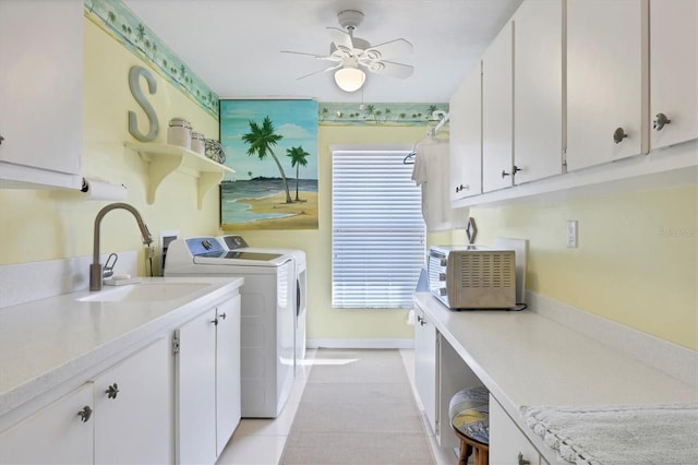 clothes washing area with cabinets, ceiling fan, sink, light tile patterned floors, and washing machine and dryer