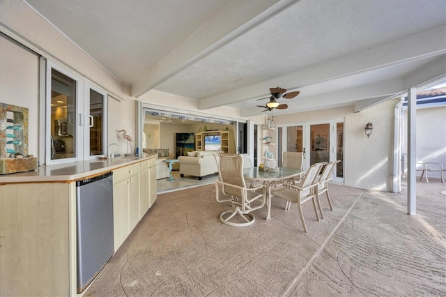 sunroom with beamed ceiling and ceiling fan