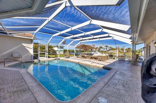 view of pool with a patio area and a lanai