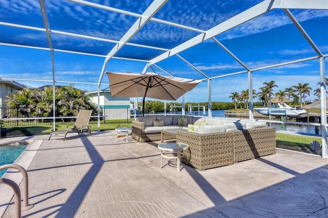 view of patio / terrace with outdoor lounge area, glass enclosure, and a water view