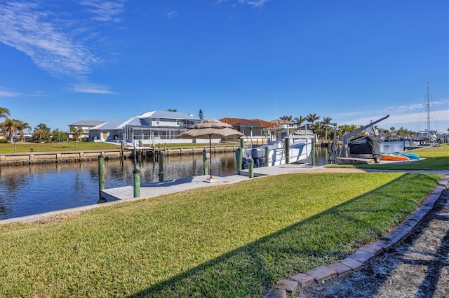 view of dock featuring a lawn and a water view