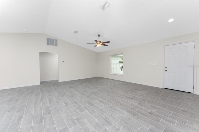 unfurnished room with ceiling fan, light wood-type flooring, and vaulted ceiling