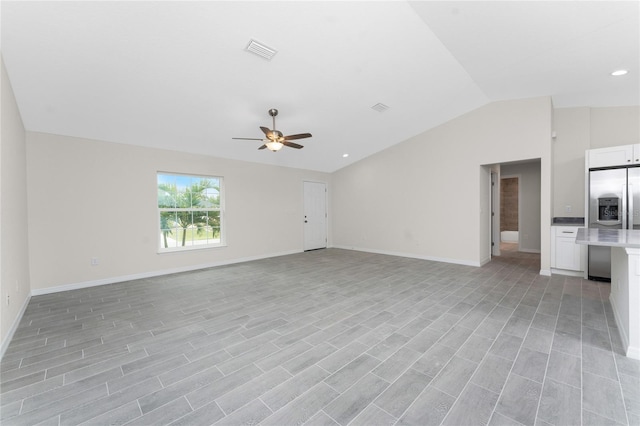 unfurnished living room featuring ceiling fan and vaulted ceiling