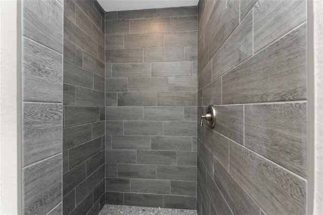 bathroom with tiled shower