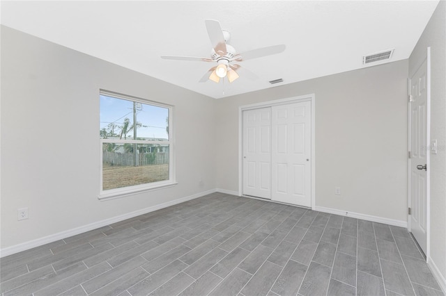 unfurnished bedroom featuring ceiling fan, a closet, and dark hardwood / wood-style floors