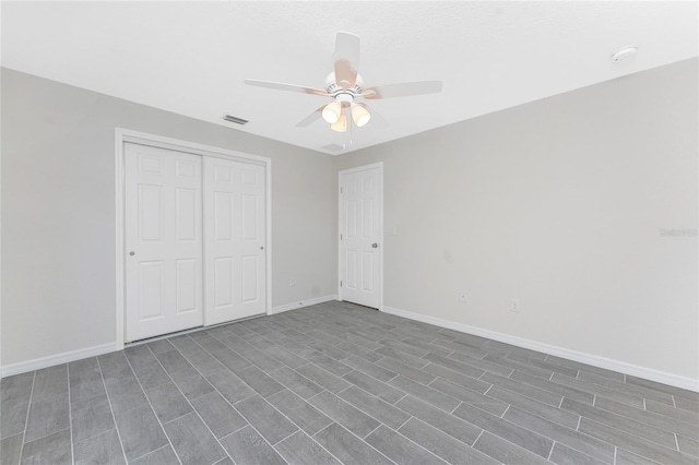 unfurnished bedroom featuring ceiling fan and a closet