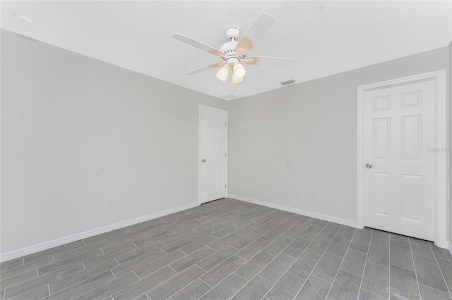 spare room with ceiling fan and a textured ceiling