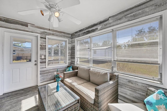 sunroom / solarium featuring a wealth of natural light and ceiling fan