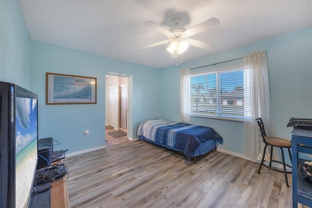 bedroom with ceiling fan and hardwood / wood-style flooring