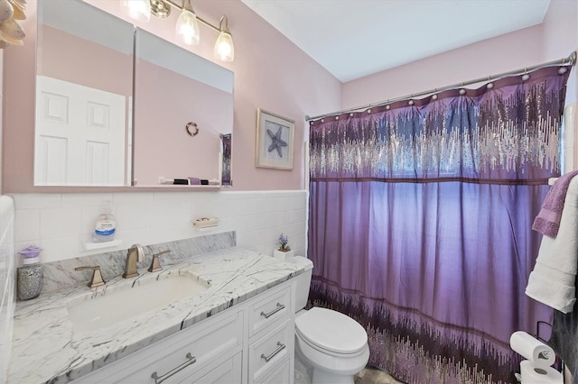 full bathroom with vanity, toilet, tile walls, and shower / tub combo with curtain