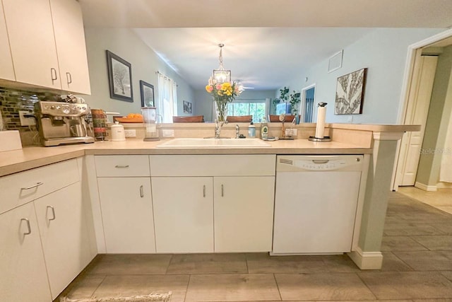 kitchen featuring dishwasher, sink, white cabinets, decorative light fixtures, and light tile patterned floors