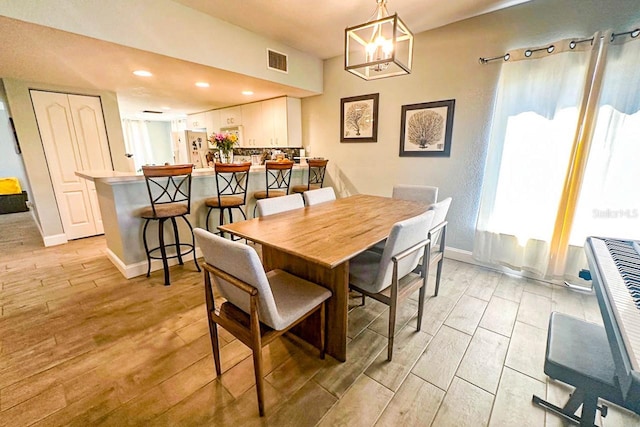 dining space featuring plenty of natural light and a notable chandelier