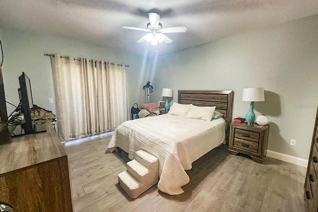 bedroom with ceiling fan and light wood-type flooring