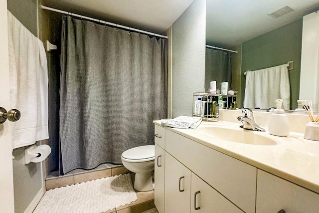 bathroom with tile patterned flooring, vanity, and toilet