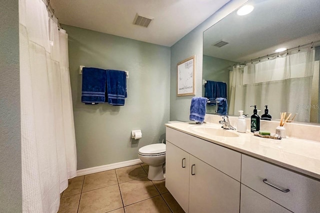 bathroom with tile patterned flooring, vanity, and toilet