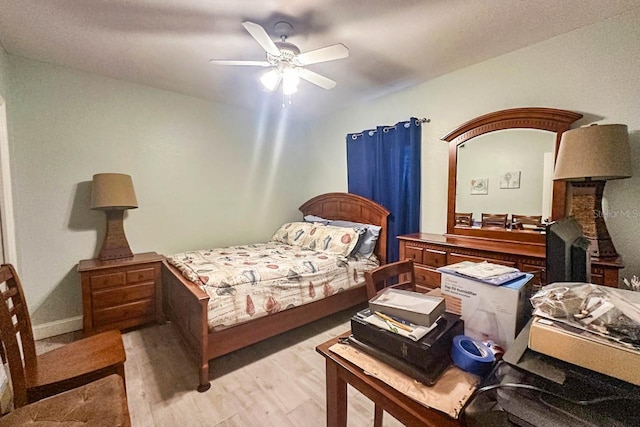 bedroom with light hardwood / wood-style flooring and ceiling fan