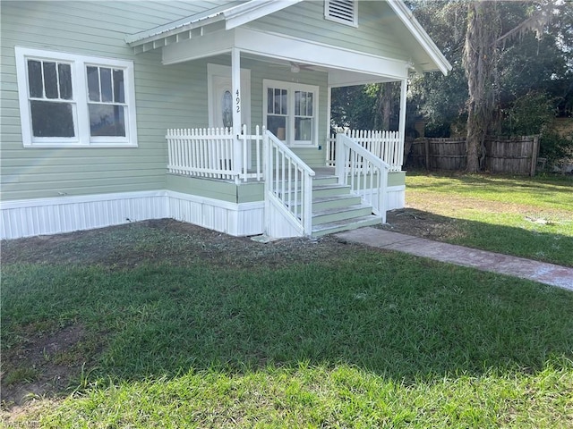 view of front of property with covered porch and a front yard