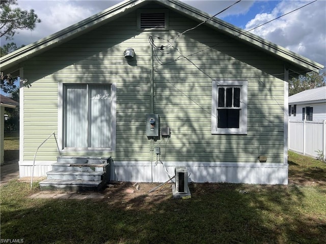 view of property exterior with a lawn