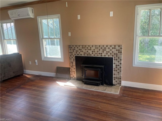 unfurnished living room featuring dark hardwood / wood-style flooring, a wood stove, and a wall mounted AC