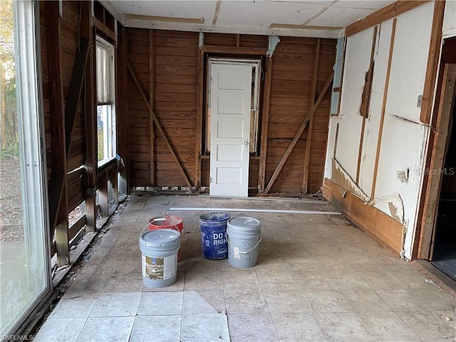 miscellaneous room featuring wood walls