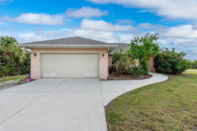 view of front of house featuring a front lawn and a garage