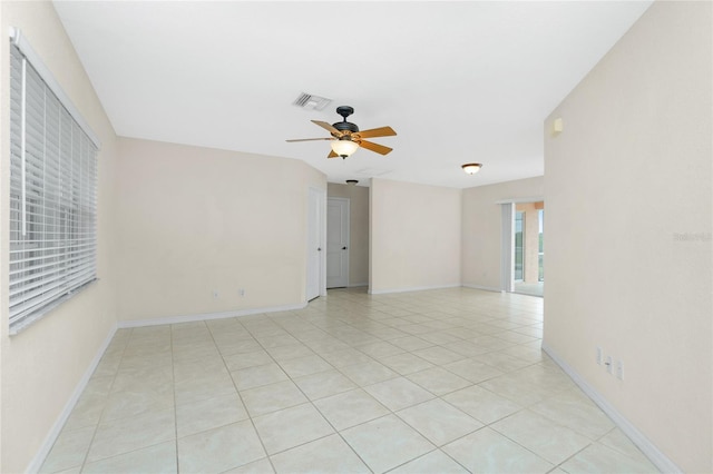 tiled spare room featuring ceiling fan