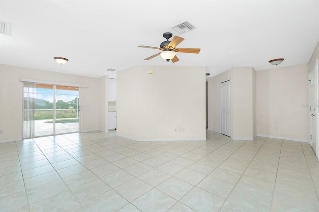 spare room featuring ceiling fan and light tile patterned flooring