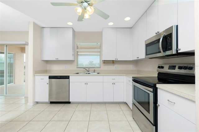 kitchen featuring white cabinetry, sink, ceiling fan, light tile patterned flooring, and appliances with stainless steel finishes