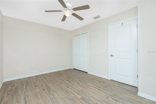 unfurnished bedroom with ceiling fan and light hardwood / wood-style floors