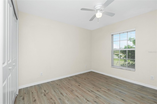 spare room with hardwood / wood-style floors and ceiling fan