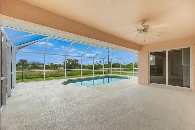 view of swimming pool featuring a lanai, ceiling fan, and a patio