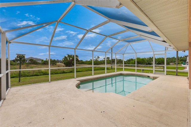 view of swimming pool with a lawn, a patio area, and a lanai