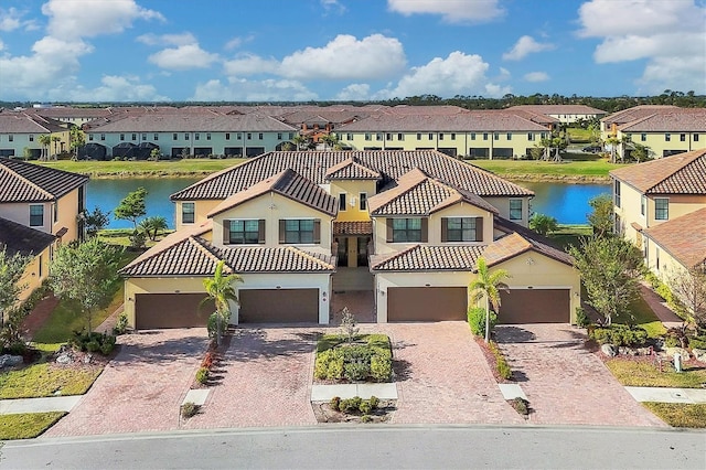 view of front of property featuring a water view and a garage