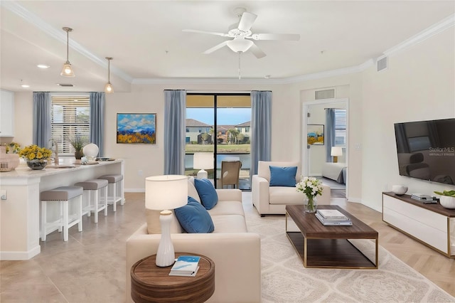 living room with light parquet floors, ceiling fan, crown molding, and sink