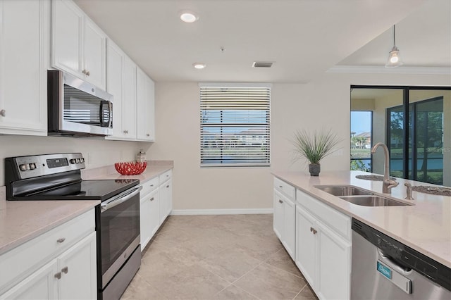 kitchen featuring stainless steel appliances, crown molding, sink, pendant lighting, and white cabinets