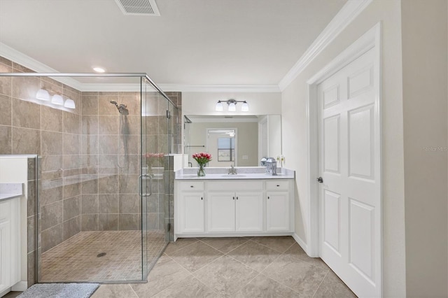 bathroom with tile patterned flooring, vanity, a shower with shower door, and ornamental molding