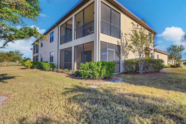 rear view of property with a lawn