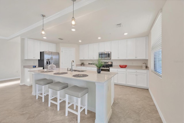 kitchen featuring a kitchen island with sink, sink, white cabinets, and appliances with stainless steel finishes