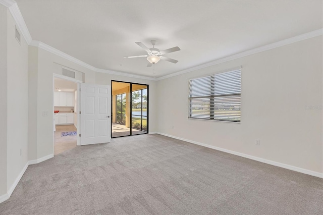 carpeted empty room with ceiling fan and ornamental molding