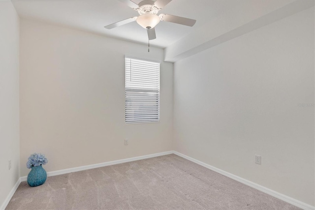 empty room featuring ceiling fan and light colored carpet