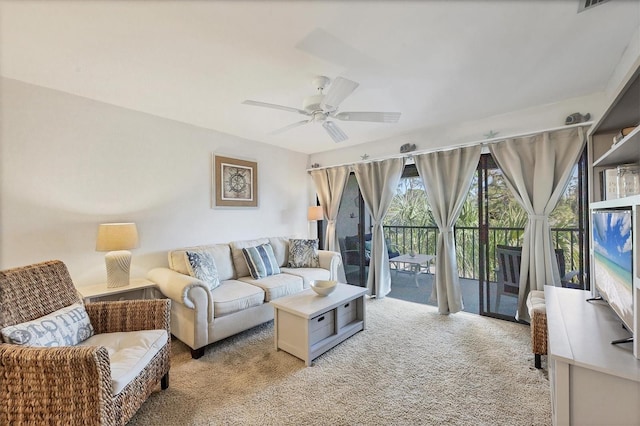 carpeted living room featuring ceiling fan