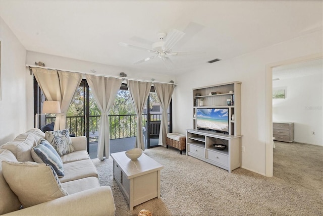 carpeted living room with ceiling fan