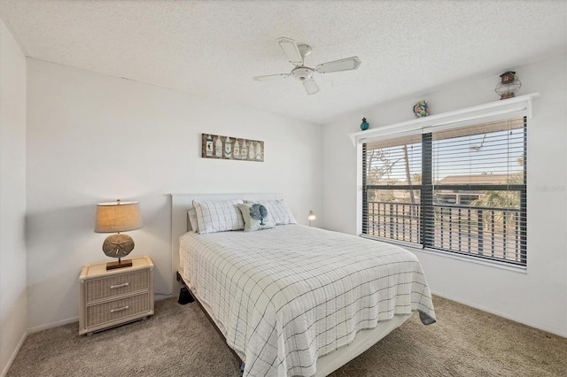 bedroom with carpet flooring, a textured ceiling, and ceiling fan