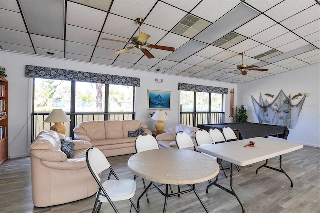 living room featuring wood-type flooring, ceiling fan, plenty of natural light, and billiards