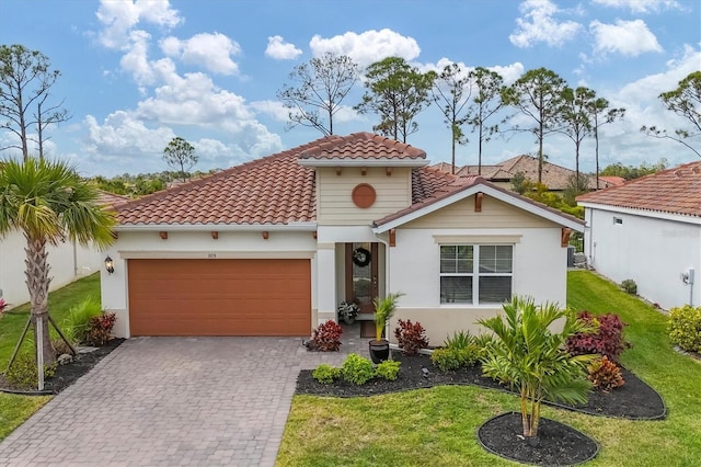 mediterranean / spanish-style home featuring a front yard and a garage